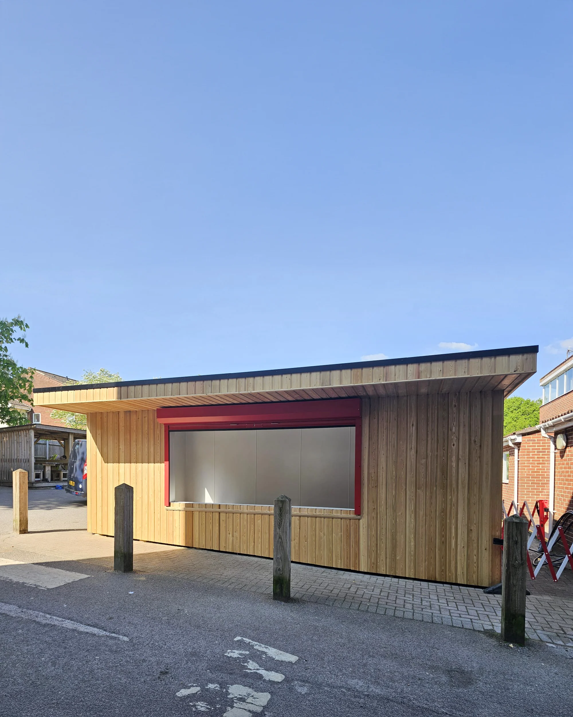 All Hallows canteen — full structure showing larch cladding and glazed pedestrian door