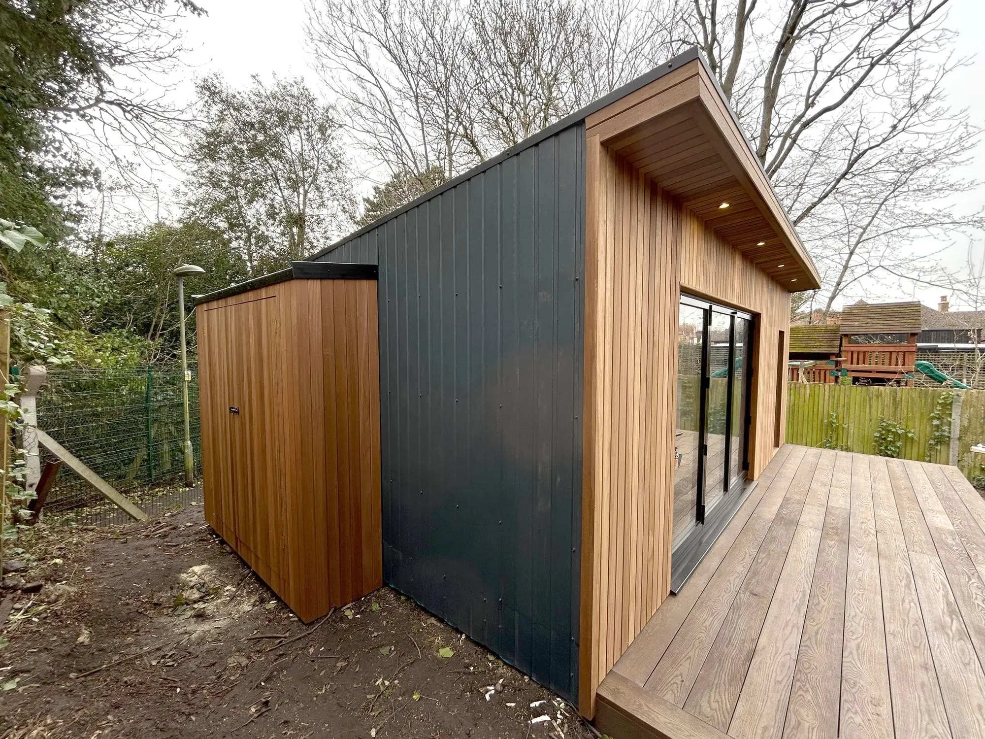 Integrated lean-to shed alongside garden room