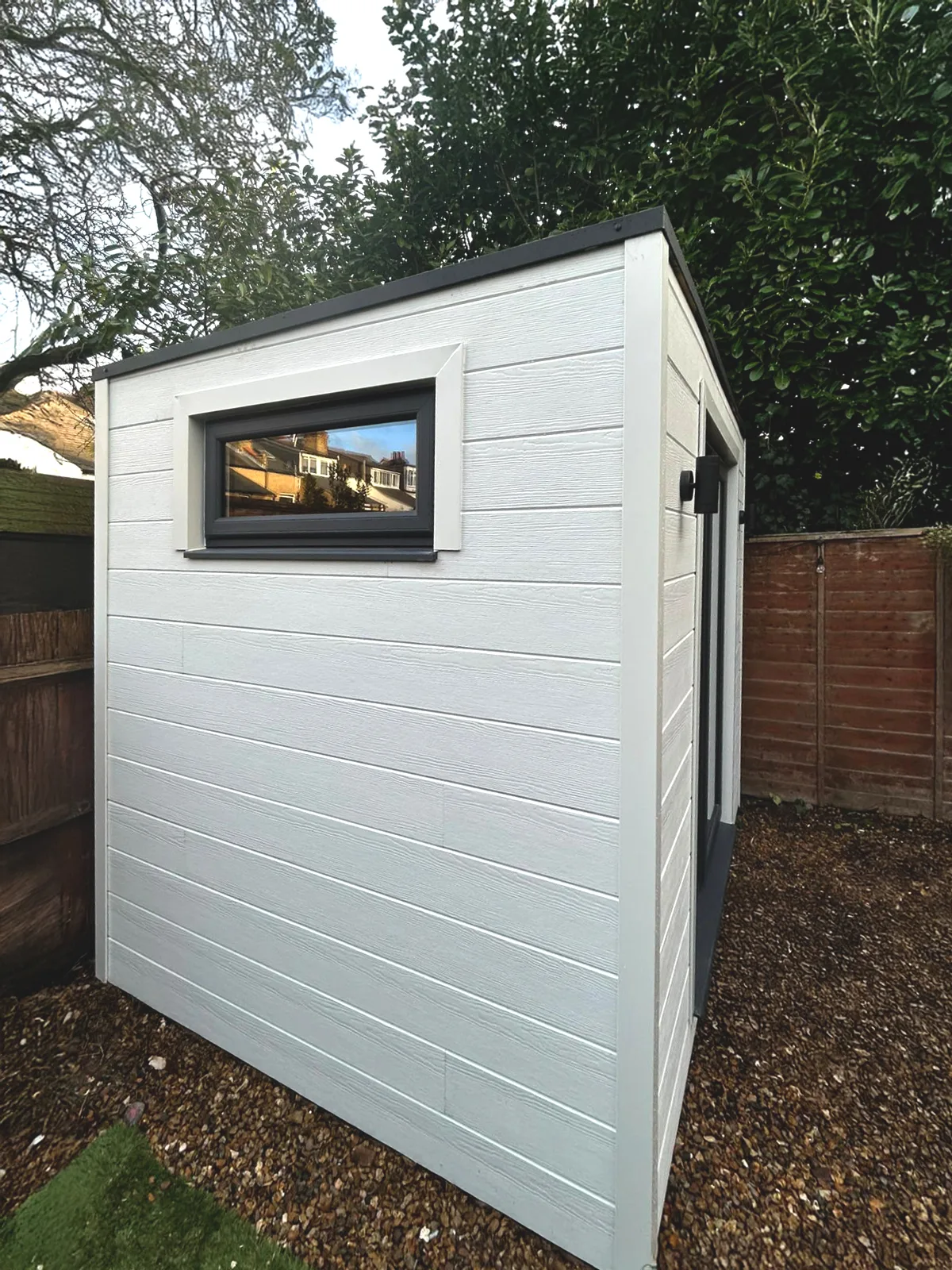 Garden pod exterior — UPVC sliding doors and white cladding