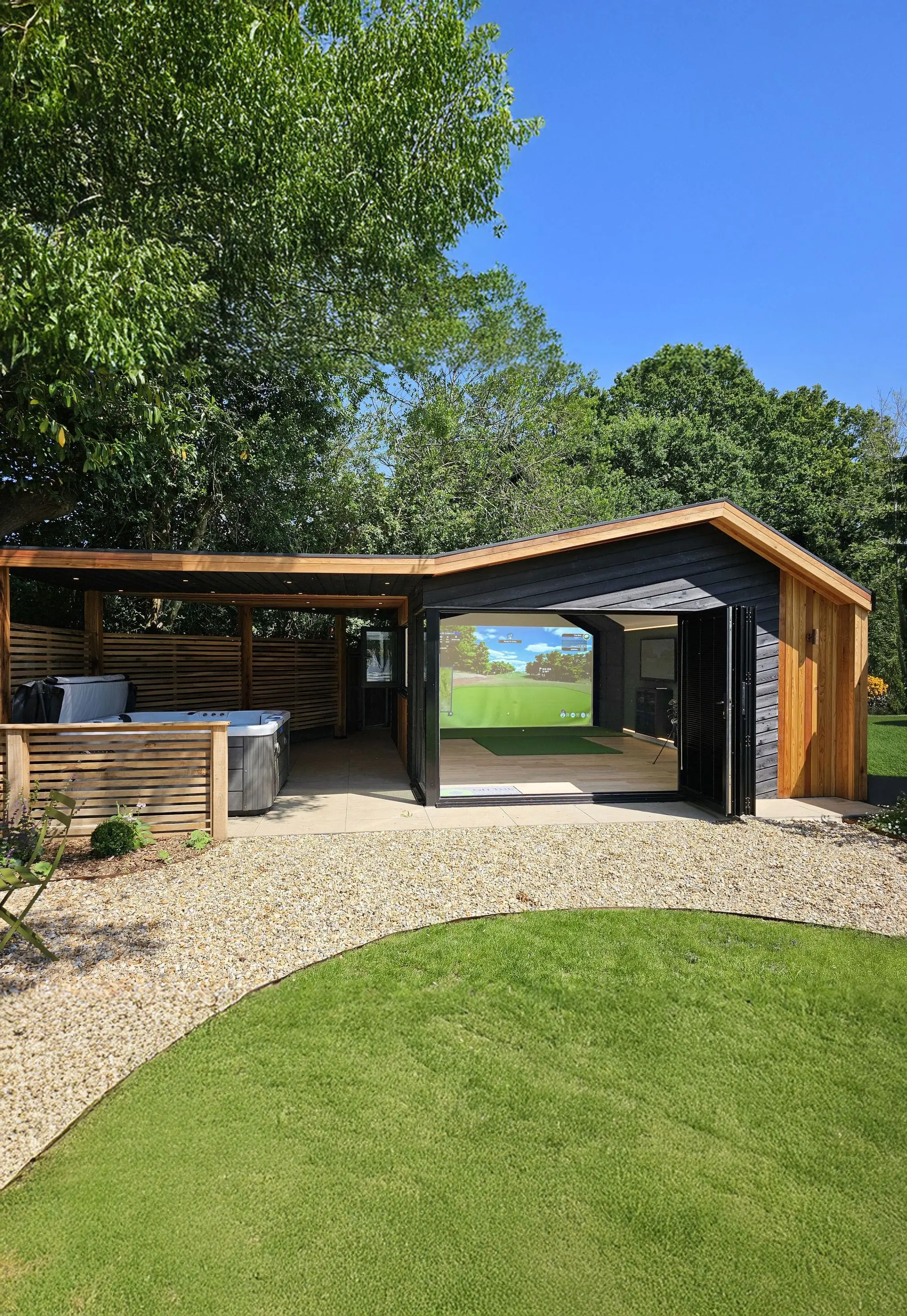 Golf simulator garden room at dusk