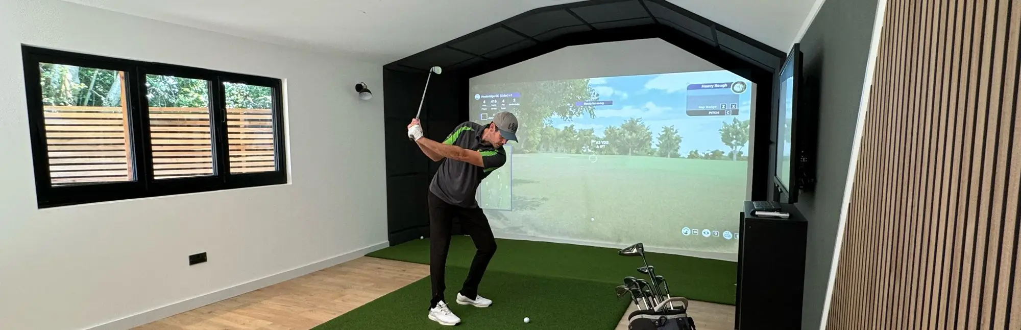 Golf simulator in action inside garden room