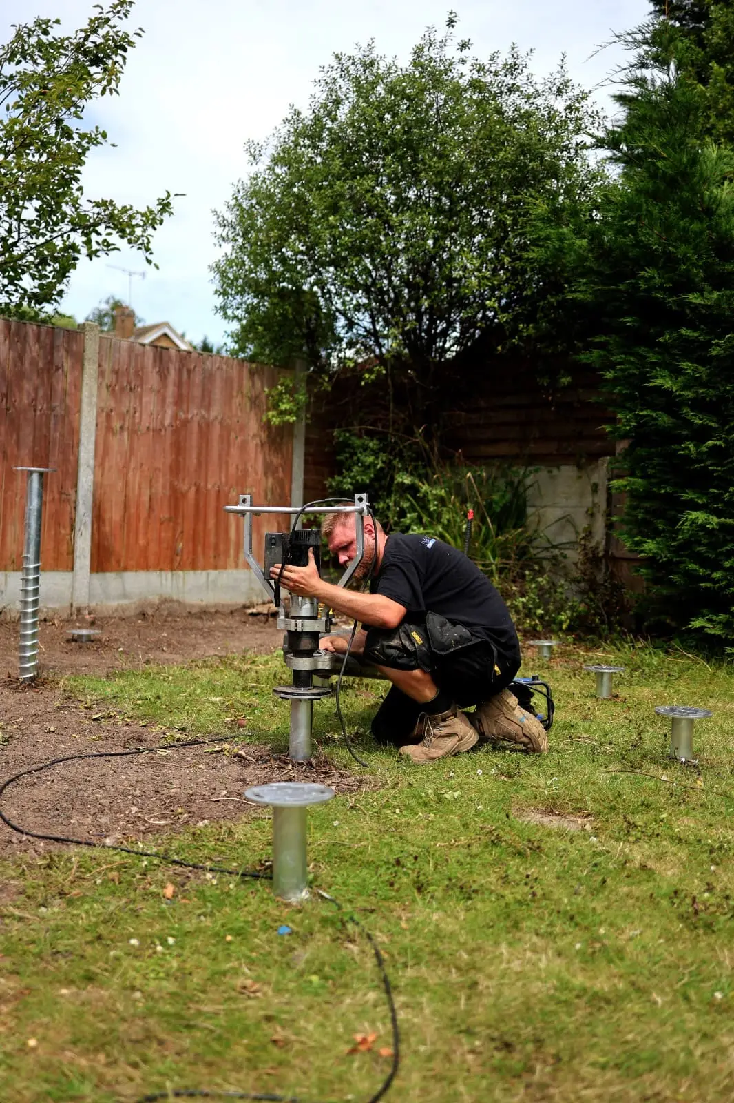 Ground screws being installed