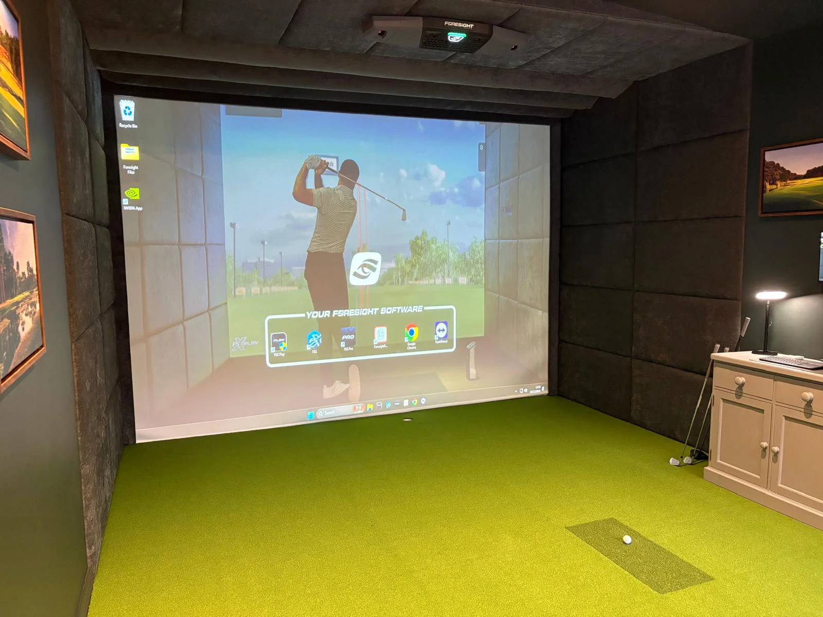 Golf simulator studio interior showing projector and screen setup