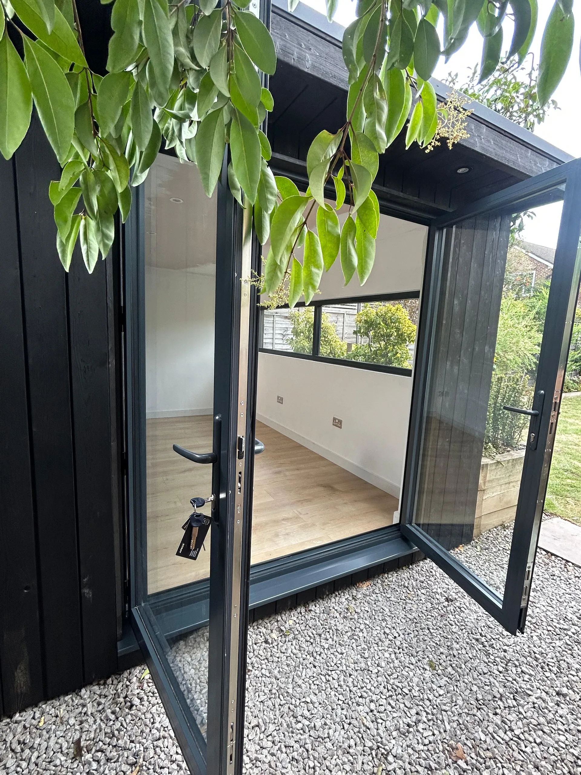 Garden office — charred spruce cladding and 2.5m desk window, East Molesey