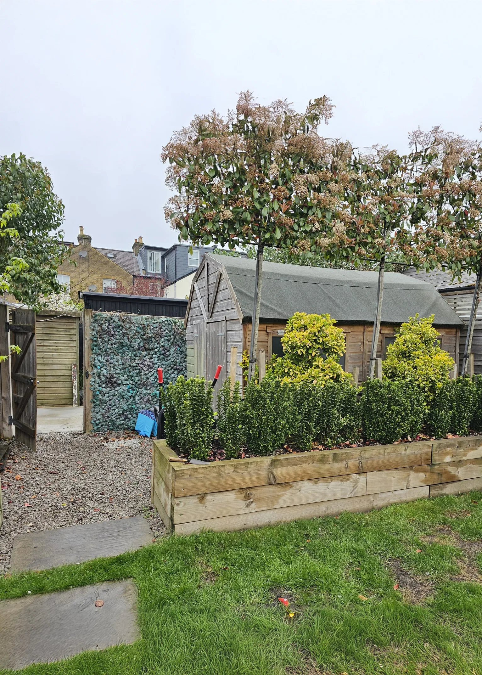 Before: old shed and fence that were replaced by the garden office