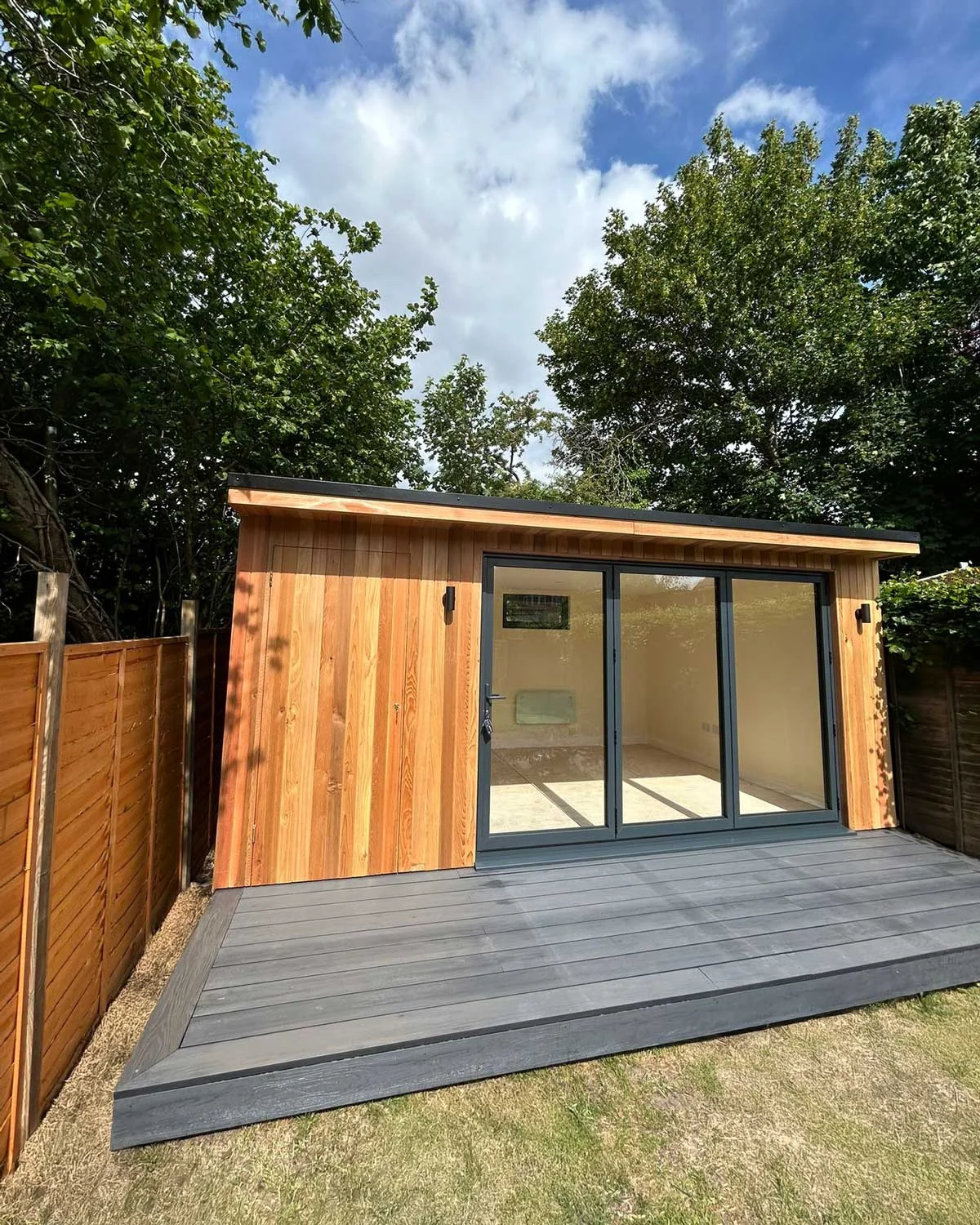 Ollie's garden office — grey composite decking and bifold doors open to garden