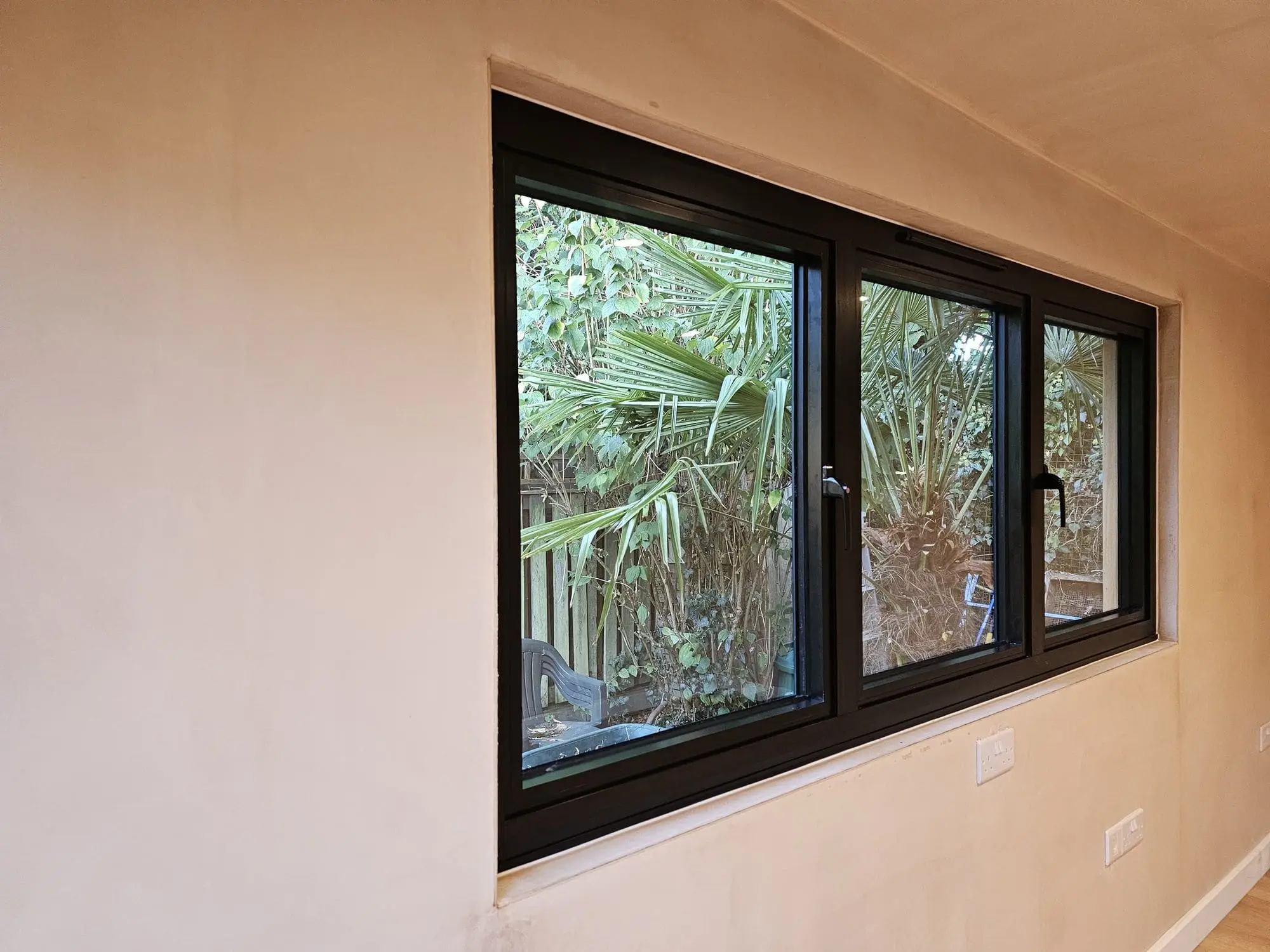 Triple aluminium window inside garden room